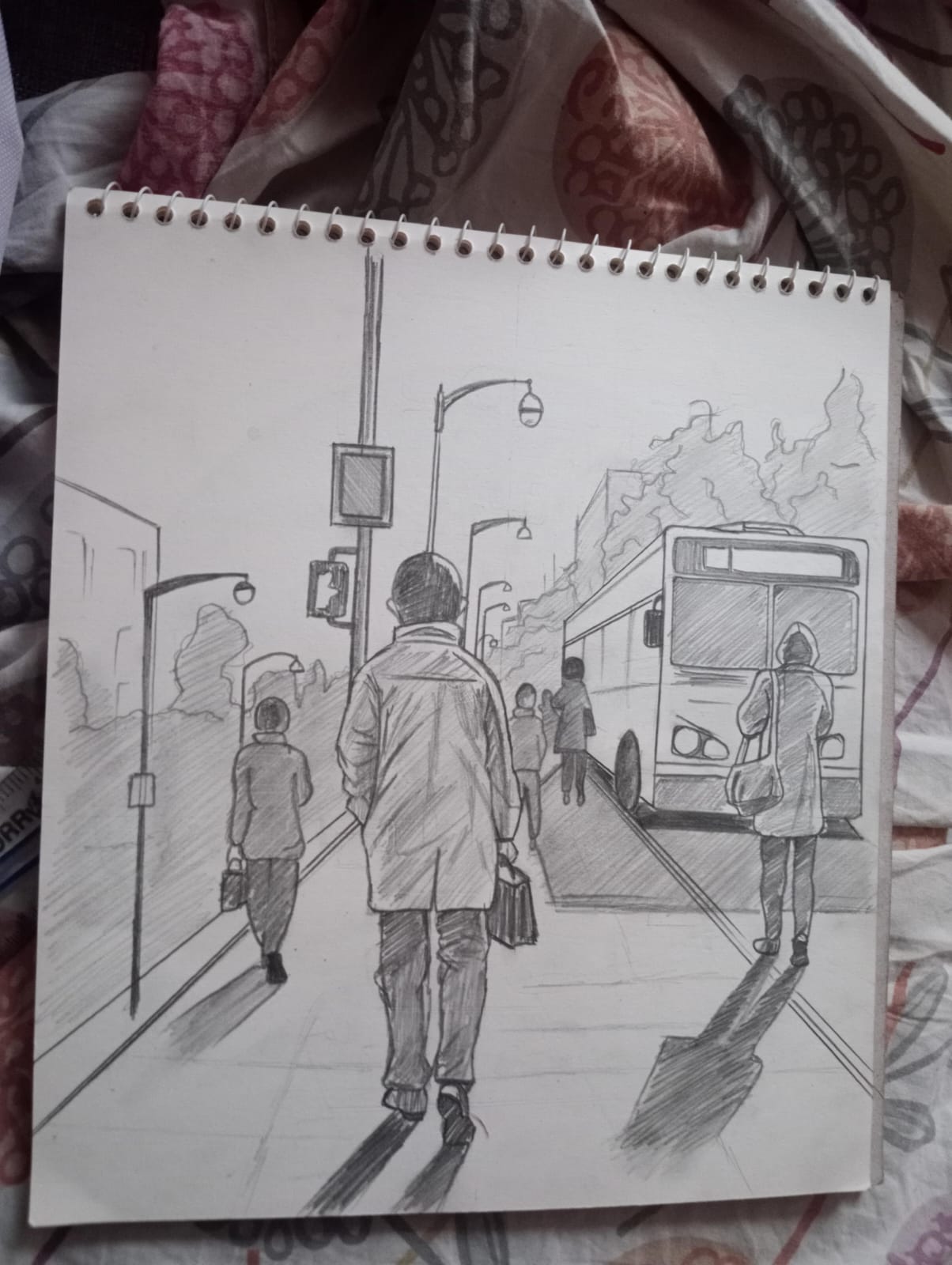 Pencil sketch of a city street with figures walking toward a bus