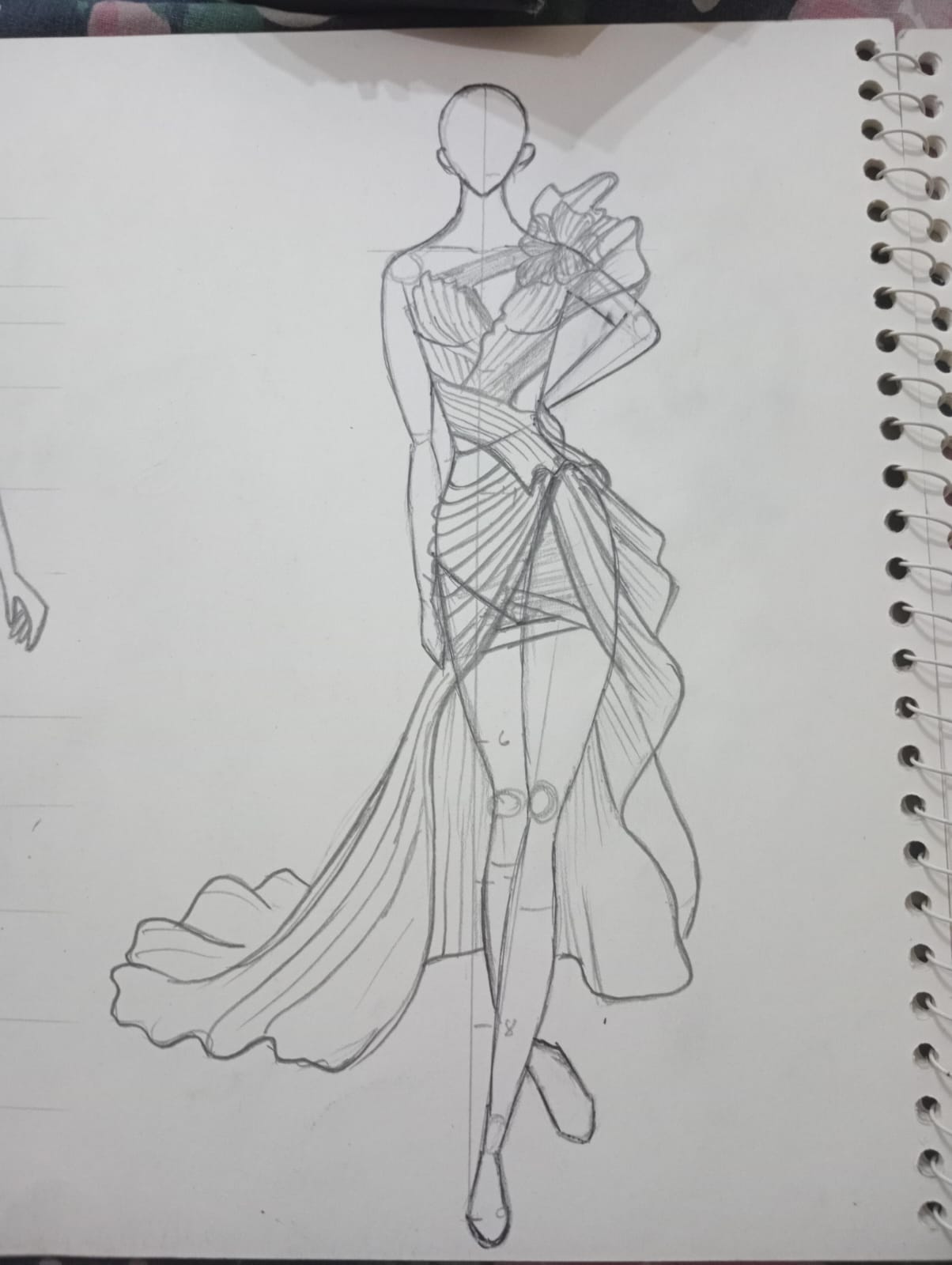 Pencil fashion illustration of a figure in a flowing draped gown
